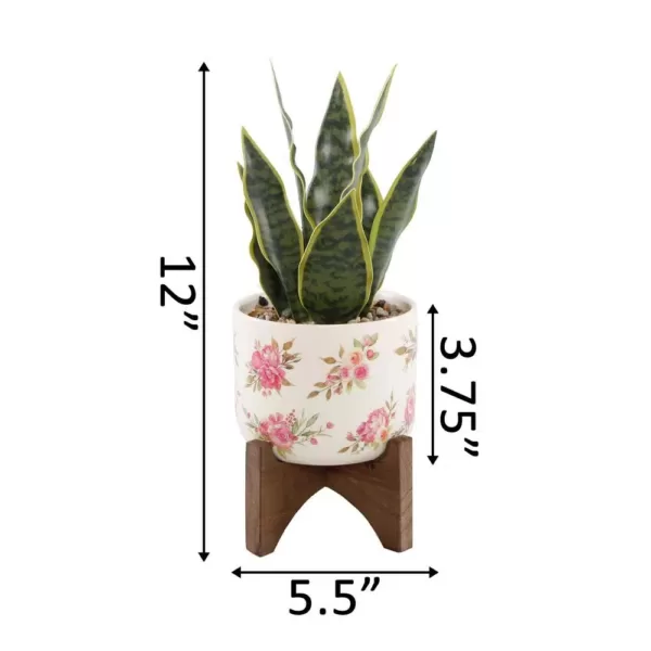 Flora Bunda 12 in. Faux Snake Plant in Flower Print White Ceramic Pot on Wood Stand